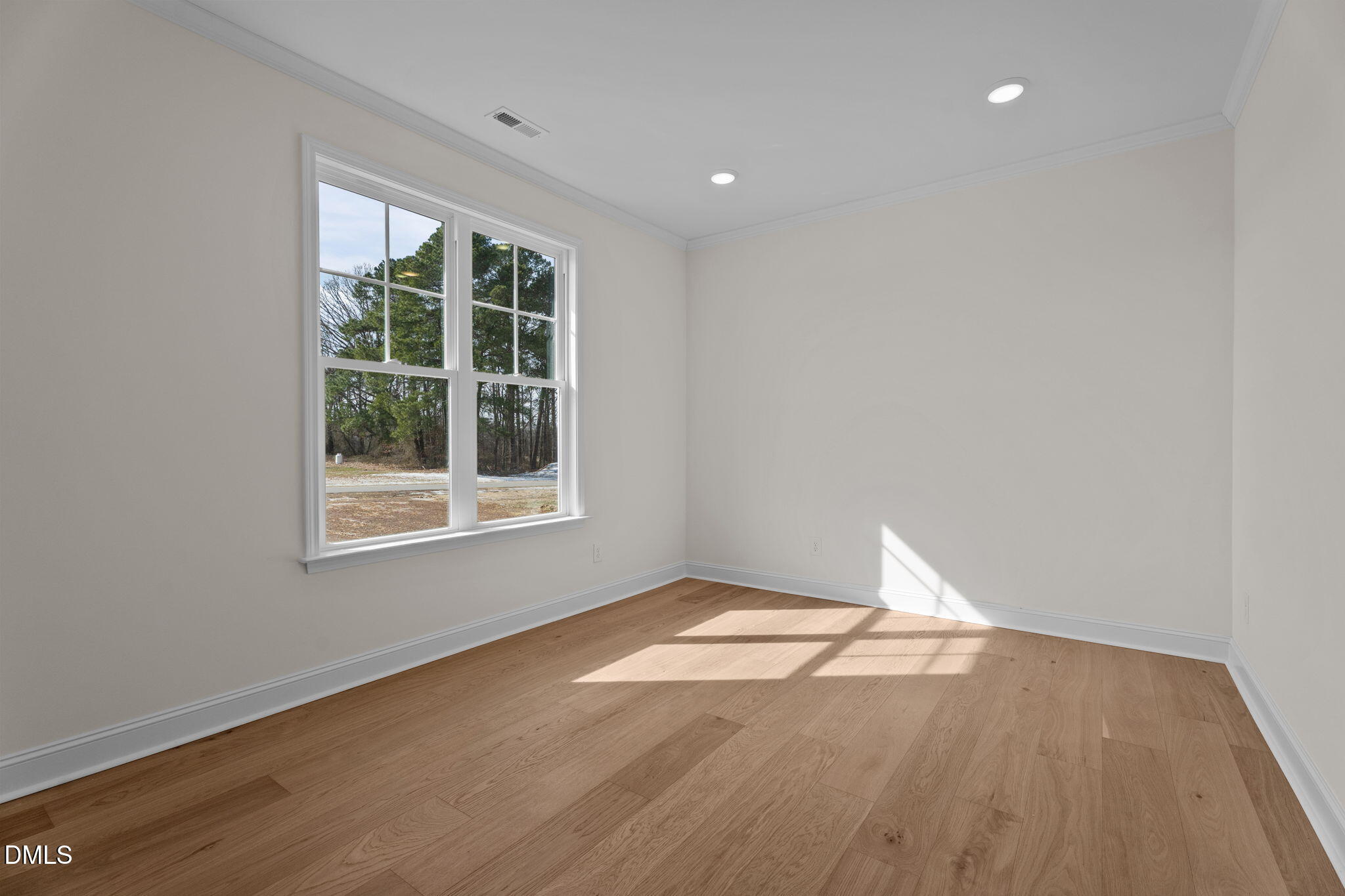 2396 Heartland Road Battleboro, NC 27809 - Photo 19 of 49 an empty room with wooden floor and windows