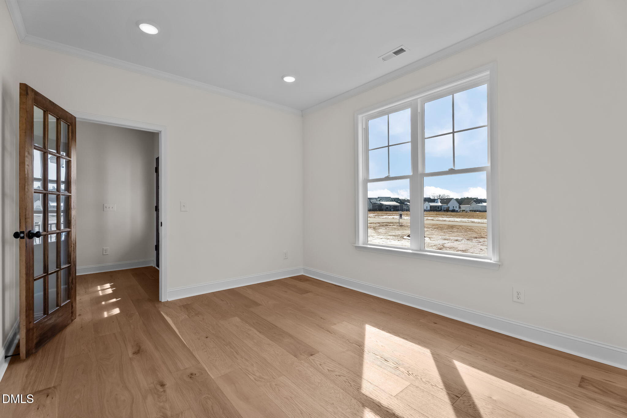 2396 Heartland Road Battleboro, NC 27809 - Photo 20 of 49 an empty room with wooden floor and windows