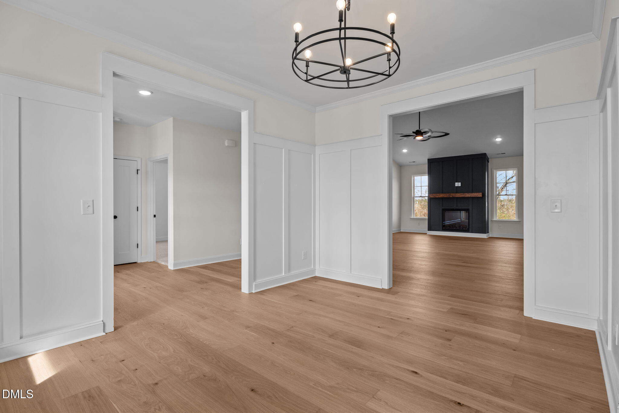 2396 Heartland Road Battleboro, NC 27809 - Photo 22 of 49 an empty room with wooden floor and chandelier
