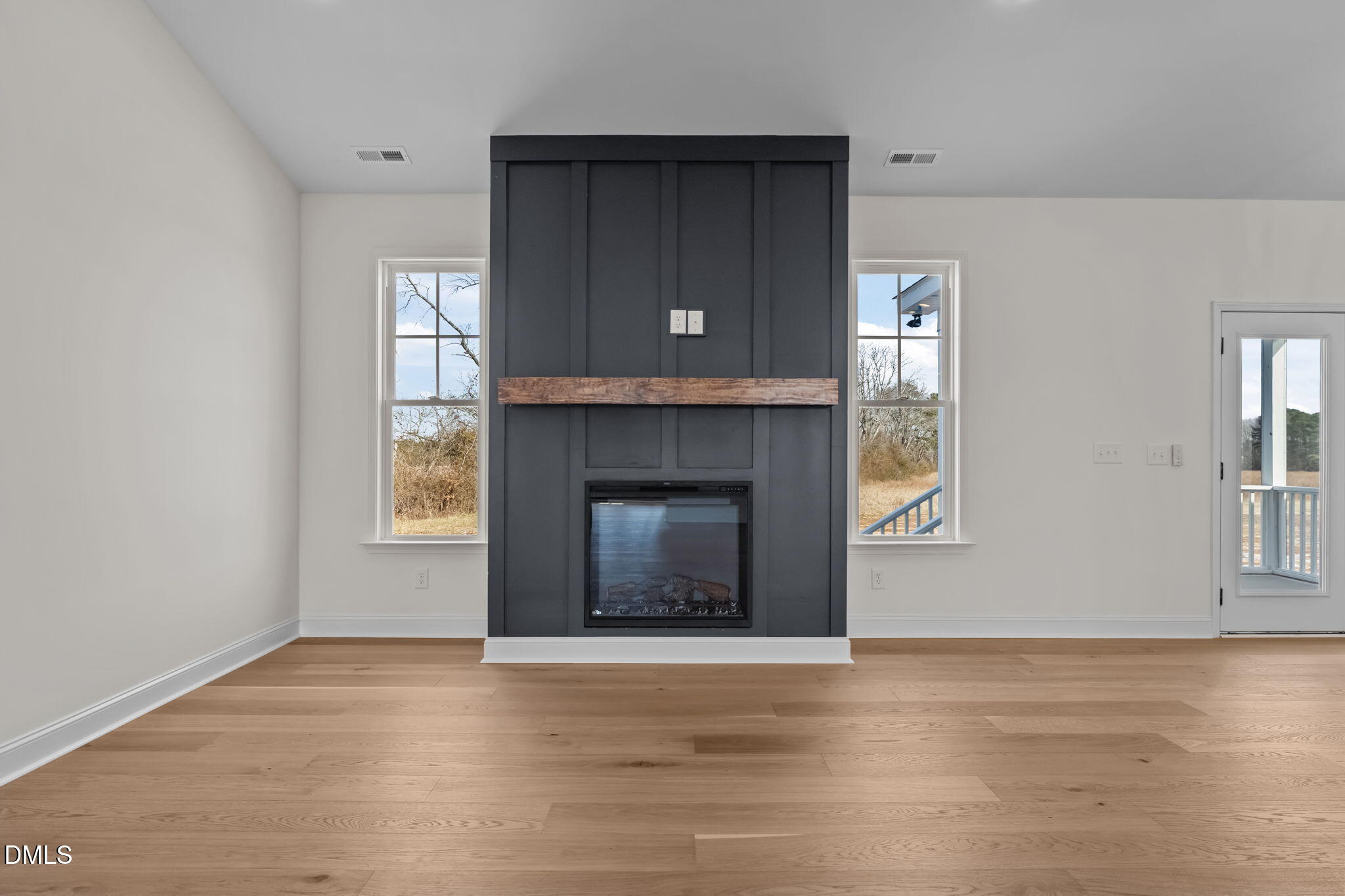 2396 Heartland Road Battleboro, NC 27809 - Photo 24 of 49 a living room with a fireplace and a window