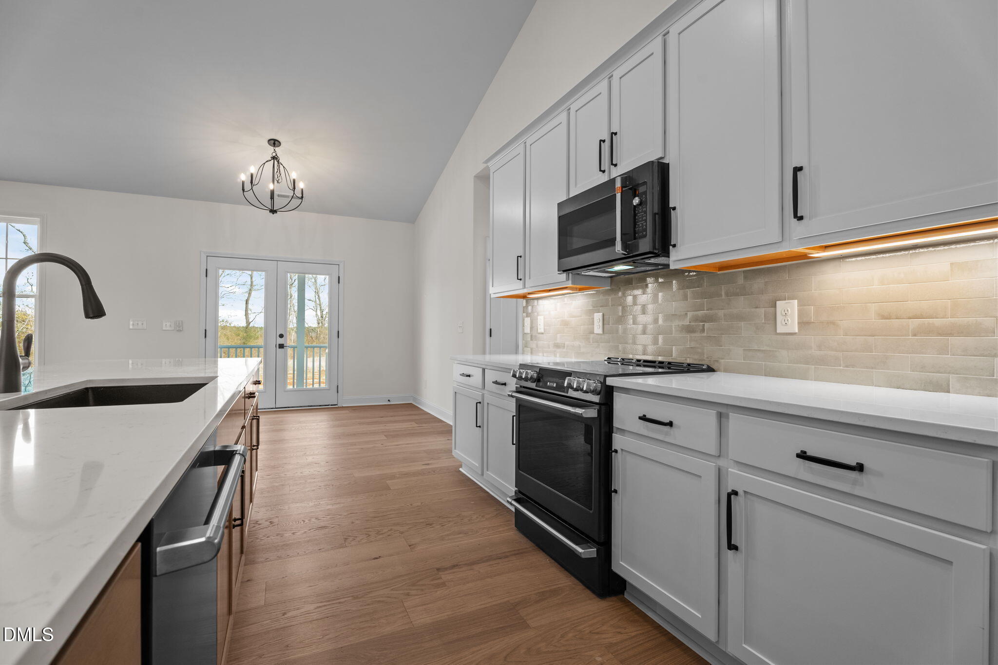 2396 Heartland Road Battleboro, NC 27809 - Photo 29 of 49 a kitchen with stainless steel appliances granite countertop a stove a sink and a microwave