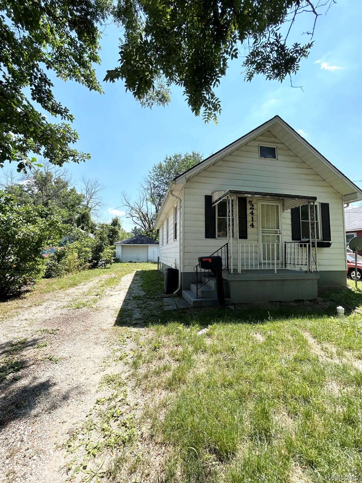 2414 Thom Street Flint, MI 48506 - Photo 2 of 8 White siding residence with a covered front porch featuring white railings
