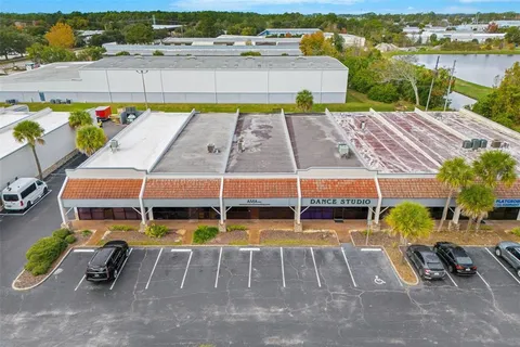 an aerial view of a swimming pool with outdoor seating and yard