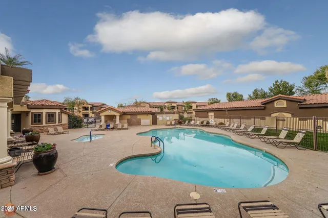 a view of a swimming pool with lawn chairs