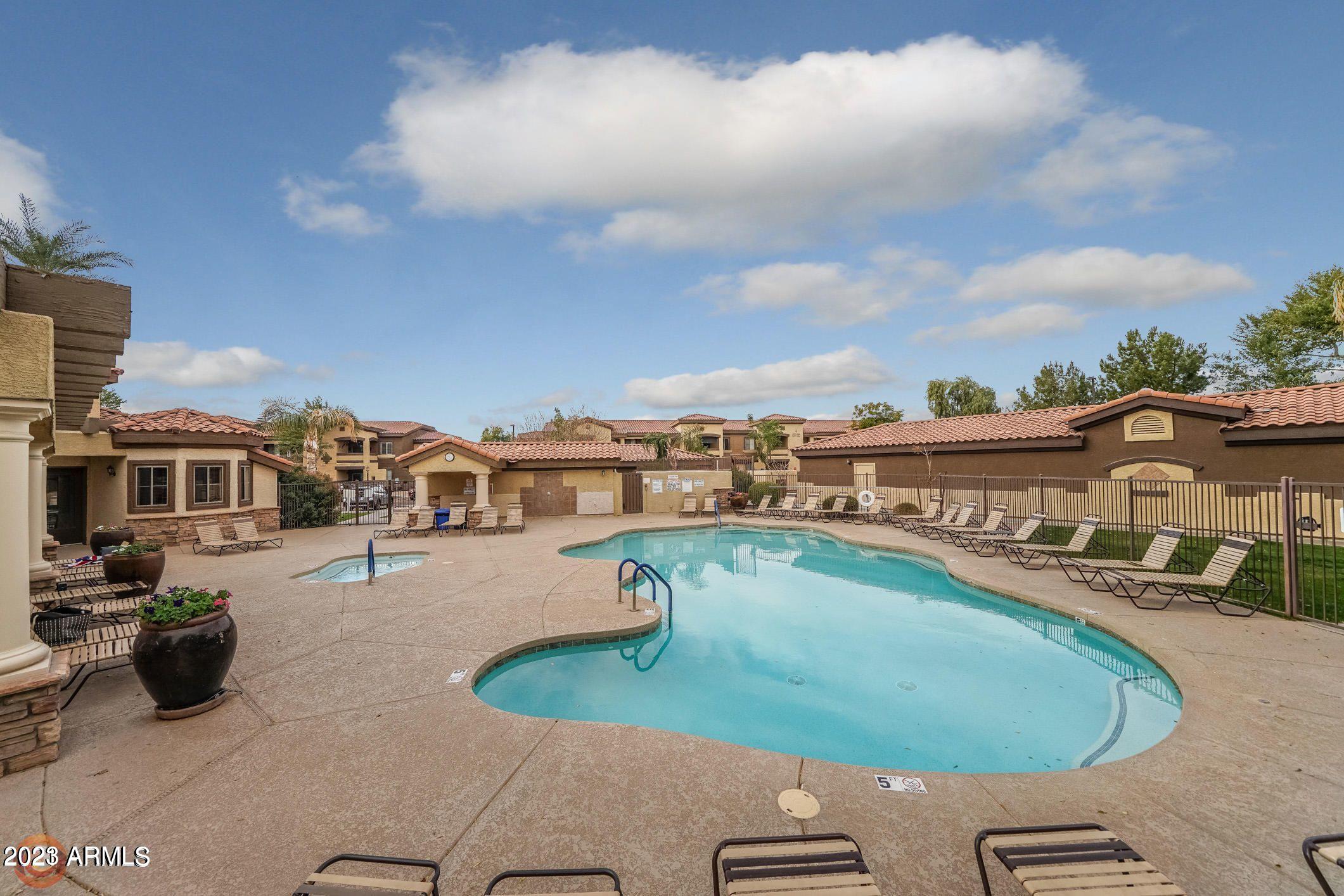 10136 East Southern Avenue, Unit 1070 Mesa, AZ 85209 - Photo 17 of 19 a view of a swimming pool with lawn chairs
