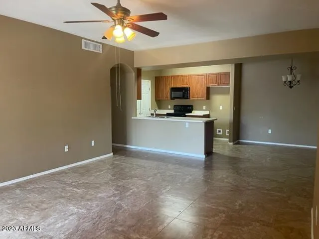 a view of a kitchen with a sink and a refrigerator