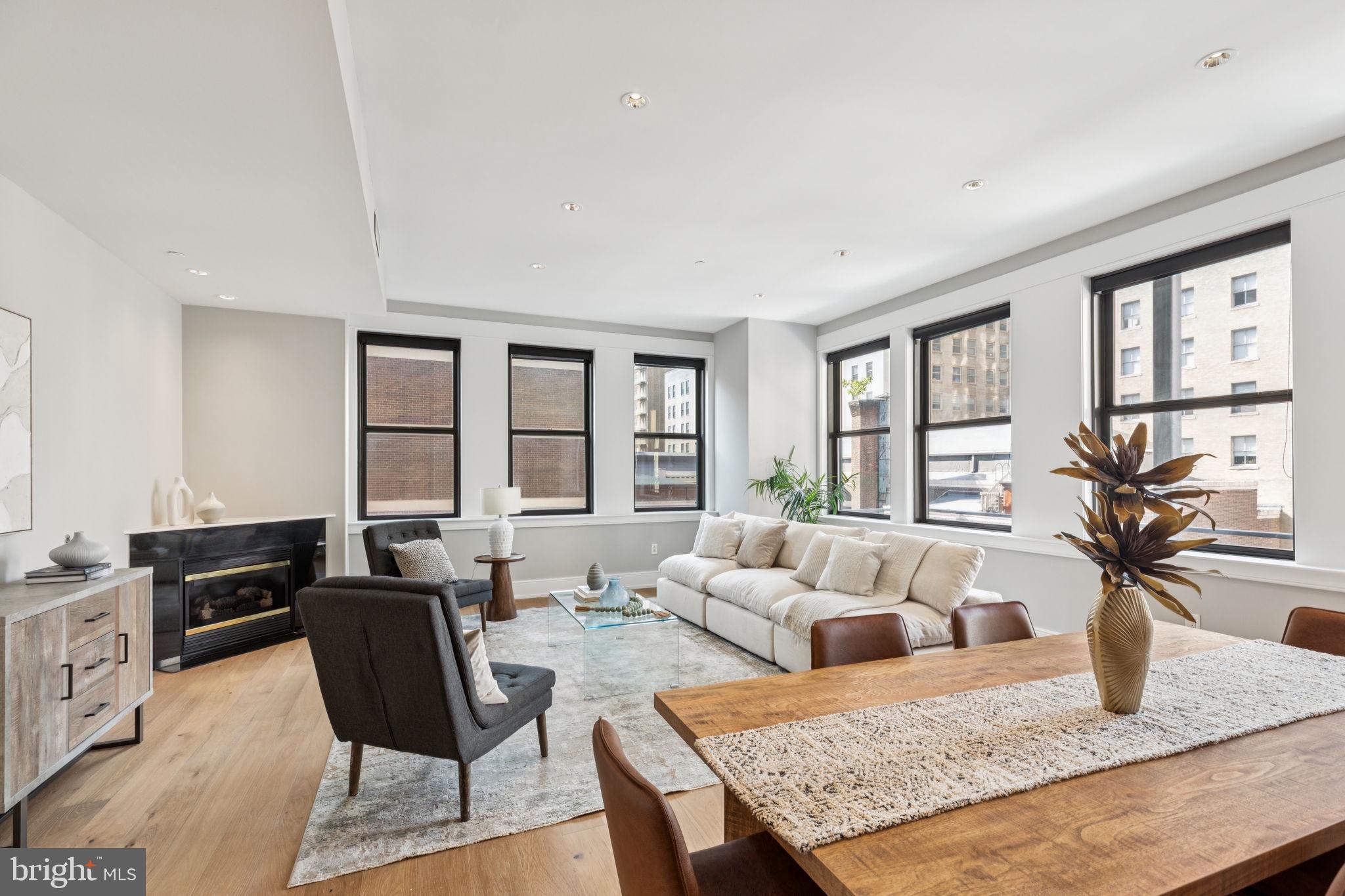 a living room with furniture and floor to ceiling windows