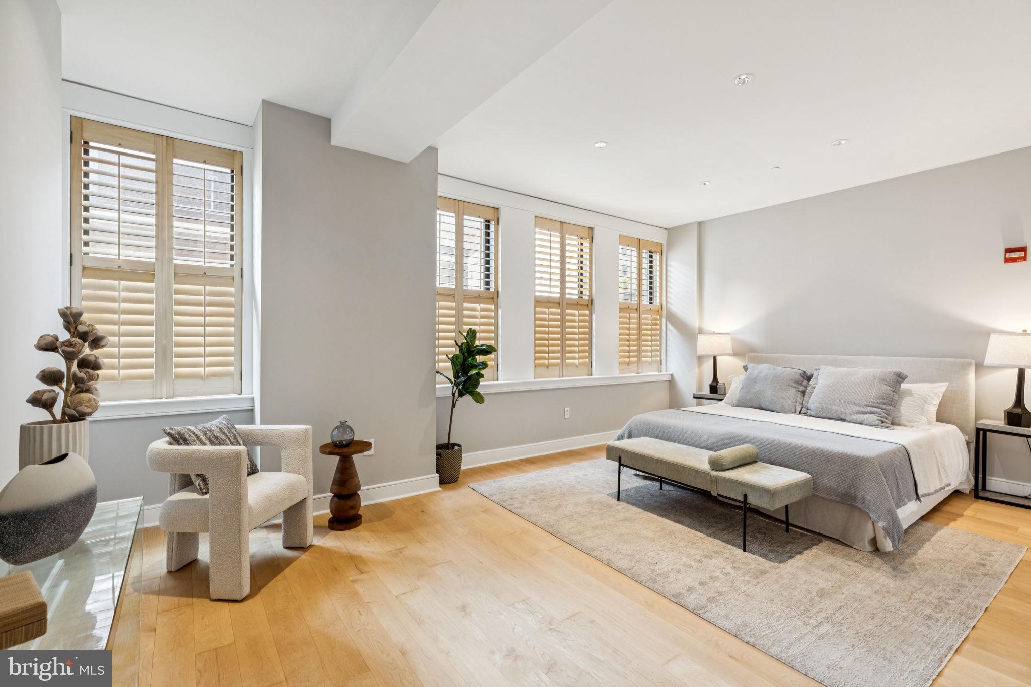 1515 Locust Street, Unit 800 Philadelphia, PA 19102 - Photo 36 of 59 a spacious bedroom with a bed and large windows