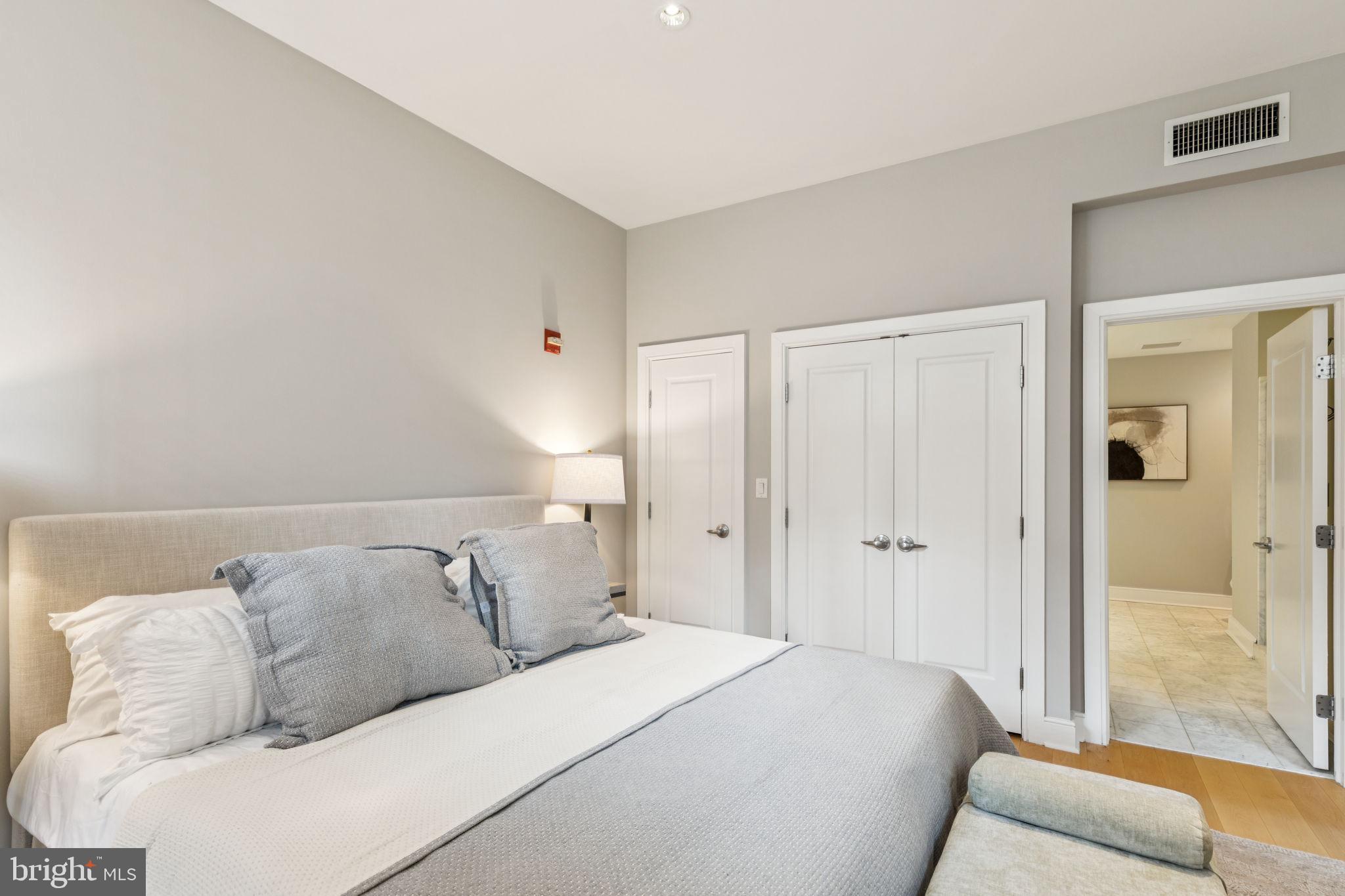 1515 Locust Street, Unit 800 Philadelphia, PA 19102 - Photo 39 of 59 a bedroom with a bed and a couch
