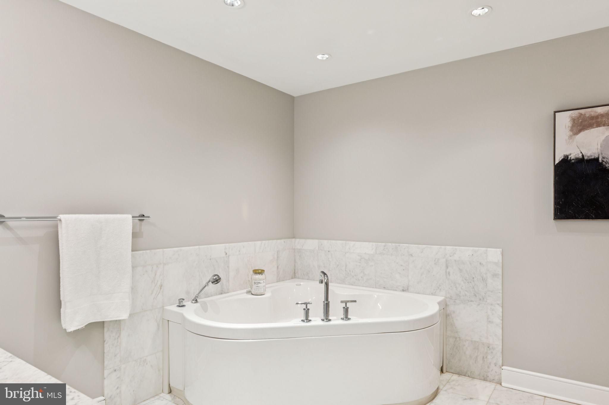 1515 Locust Street, Unit 800 Philadelphia, PA 19102 - Photo 45 of 59 a white bath tub sitting in a bathroom