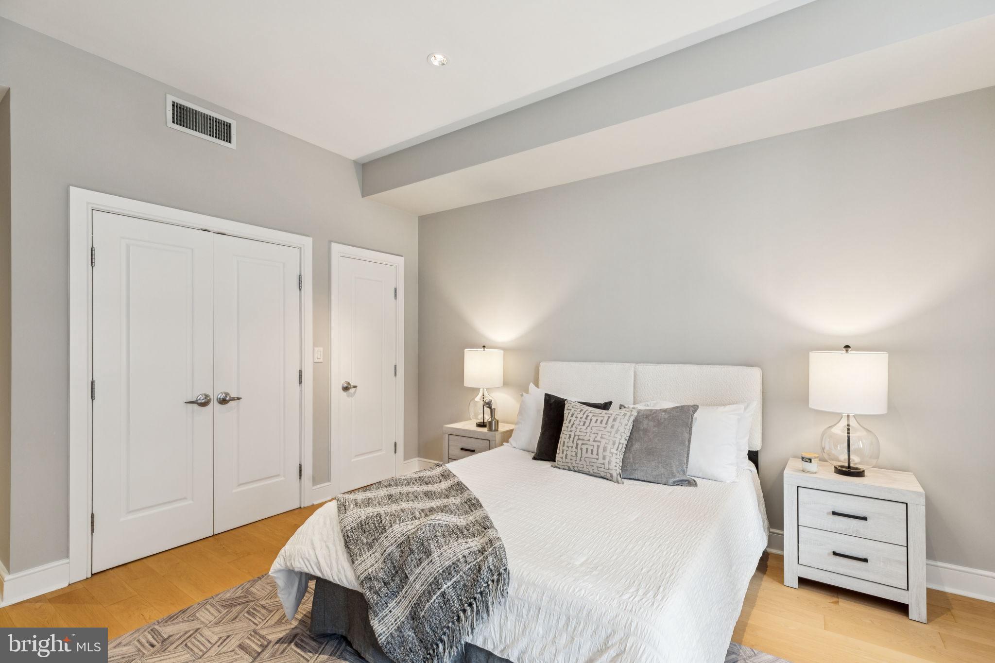 1515 Locust Street, Unit 800 Philadelphia, PA 19102 - Photo 51 of 59 a bedroom with a bed and a lamp
