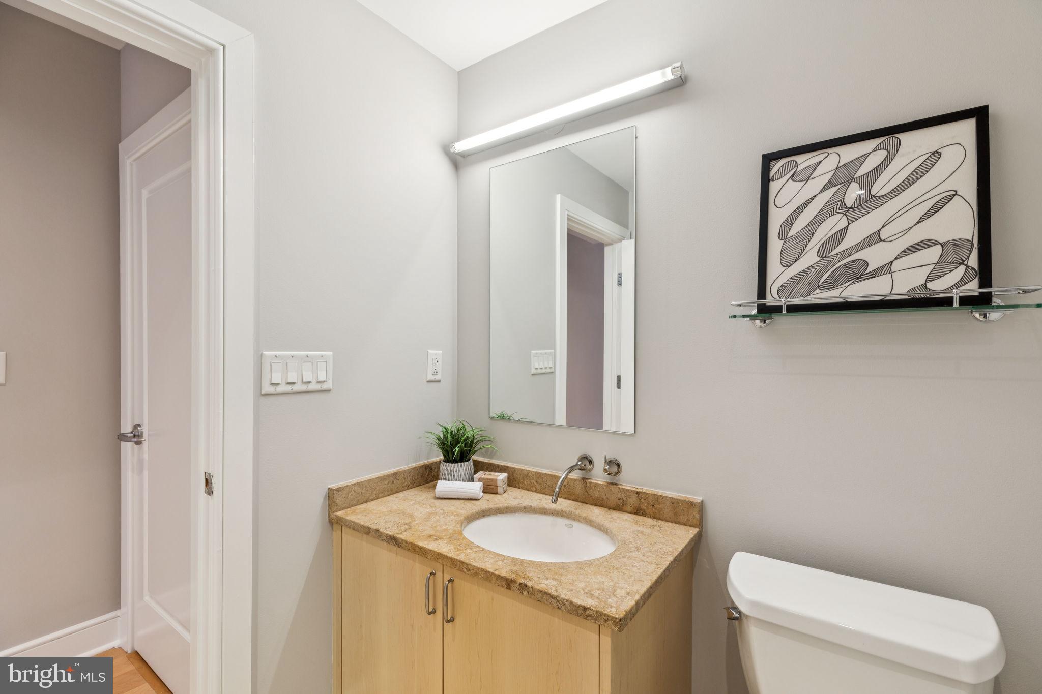 1515 Locust Street, Unit 800 Philadelphia, PA 19102 - Photo 54 of 59 a bathroom with a toilet sink and mirror