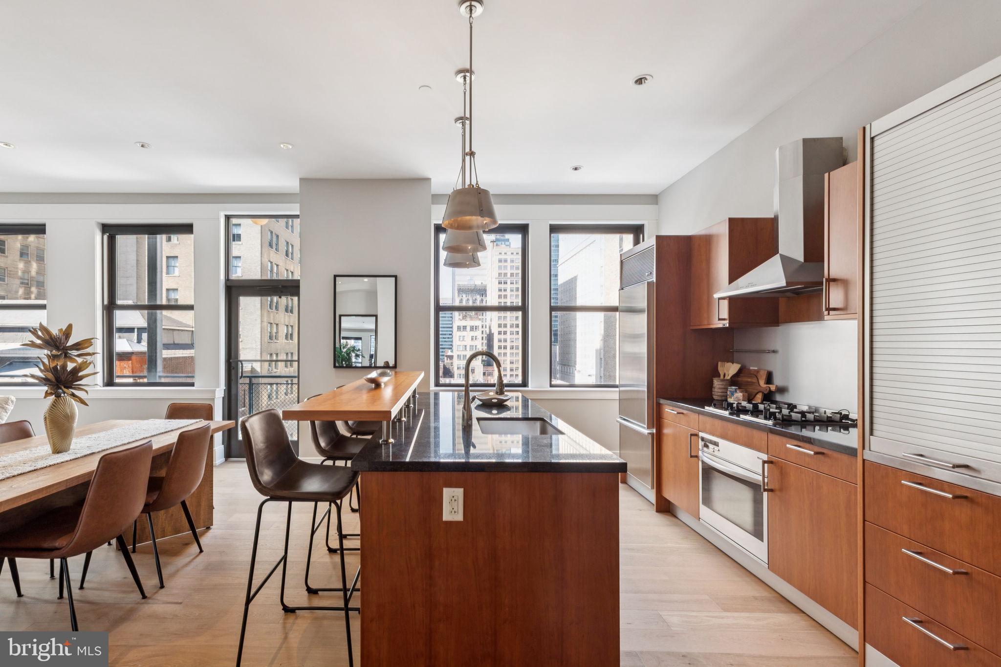 1515 Locust Street, Unit 800 Philadelphia, PA 19102 - Photo 9 of 59 a large kitchen with a table and chairs in it