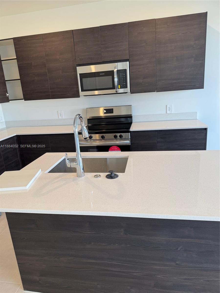 18951 Southwest 344th Terrace Homestead, FL 33034 - Photo 2 of 14 a kitchen with a stove and a microwave