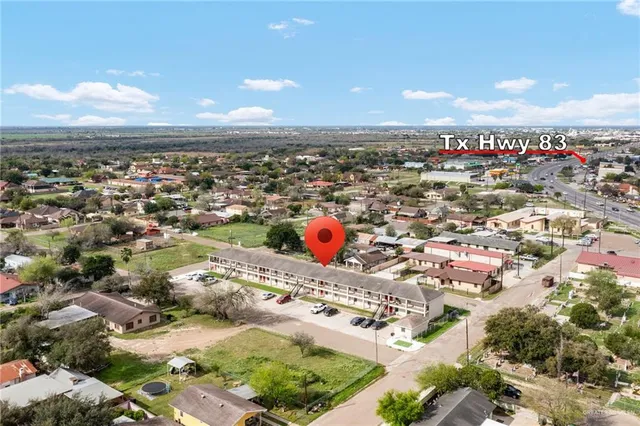 an aerial view of residential houses with outdoor space