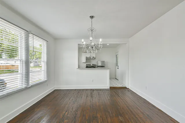 a view of a room with window and wooden floor