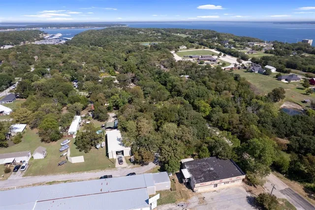 an aerial view of residential house with space and trees all around