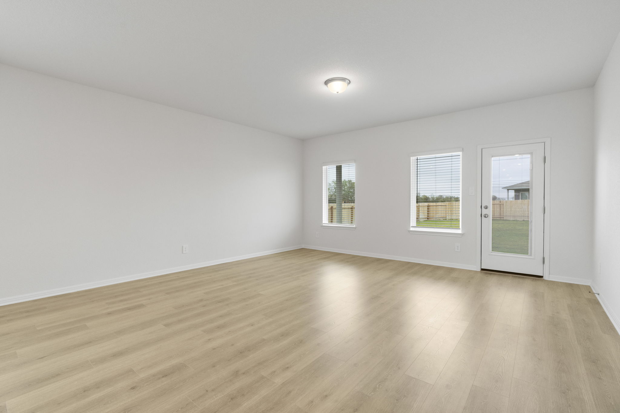 104 Boondoggle Ridge Cedar Creek, TX 78612 - Photo 16 of 33 an empty room with wooden floor and windows