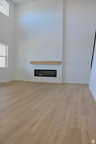 2613 Scarlet Road, Unit 258 Eagle Mountain, UT 84005 - Photo 8 of 32 Floor-to-ceiling fireplace feature wall with a light wood-finish mantel and a linear electric fireplace