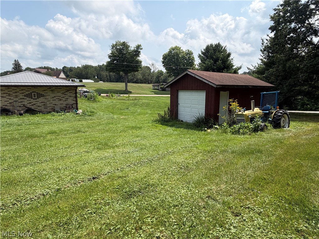 3246 Tabor Ridge Road Northeast Mineral City, OH 44656 - Photo 24 of 29 Expansive grassy grounds with two detached outbuildings and mature trees