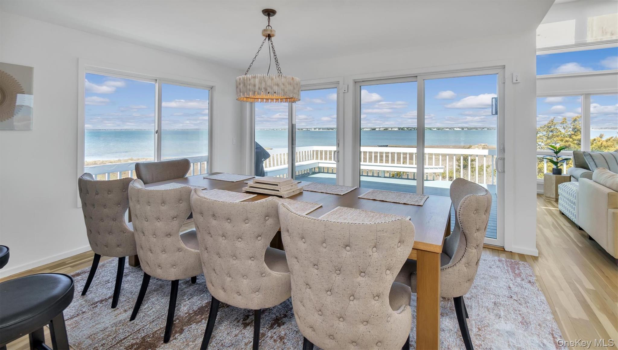552 Dune Road Westhampton, NY 11978 - Photo 12 of 32 a dining room with furniture a chandelier and wooden floor