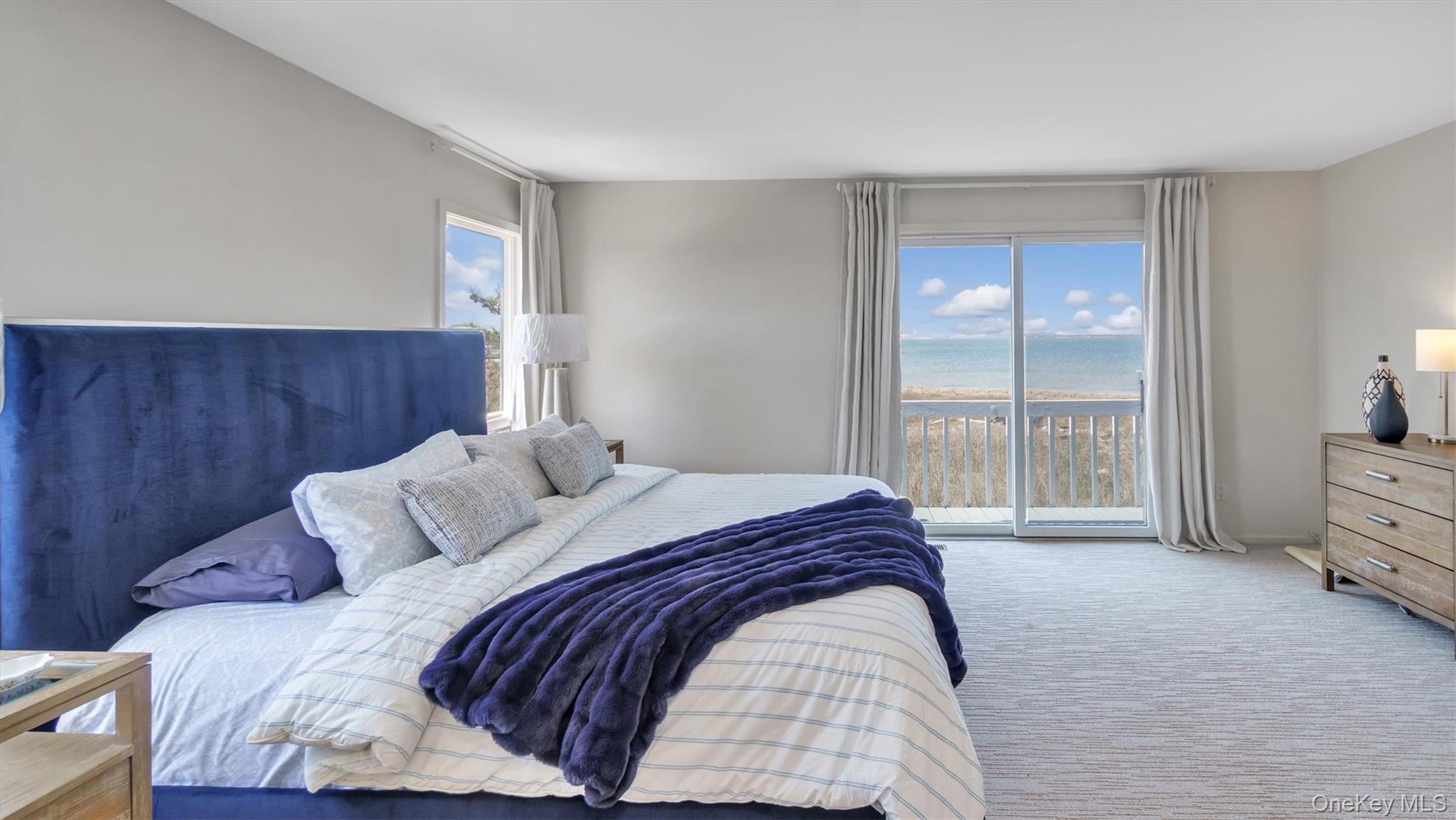 552 Dune Road Westhampton, NY 11978 - Photo 17 of 32 a bed sitting in a bedroom next to a window