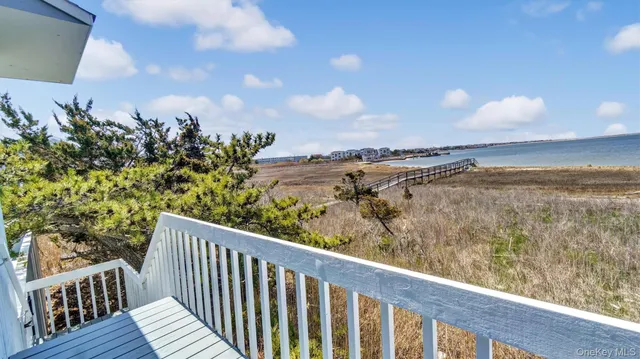 a balcony with wooden floor and city view