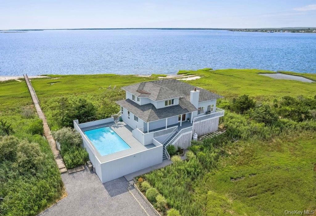 552 Dune Road Westhampton, NY 11978 - Photo 2 of 32 an aerial view of a house with a swimming pool
