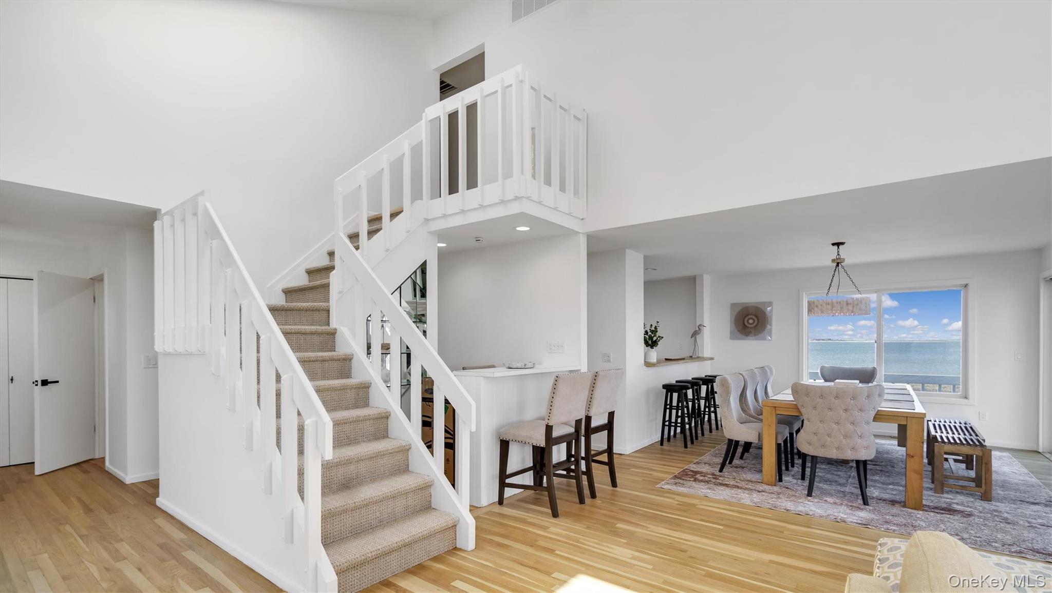 552 Dune Road Westhampton, NY 11978 - Photo 24 of 32 a view of entryway dining room and hall with wooden floor