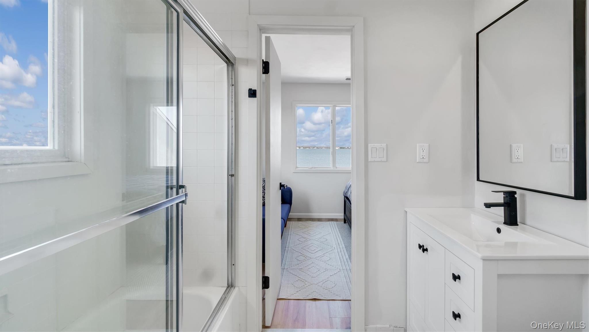 552 Dune Road Westhampton, NY 11978 - Photo 28 of 32 a bathroom with a sink and a mirror