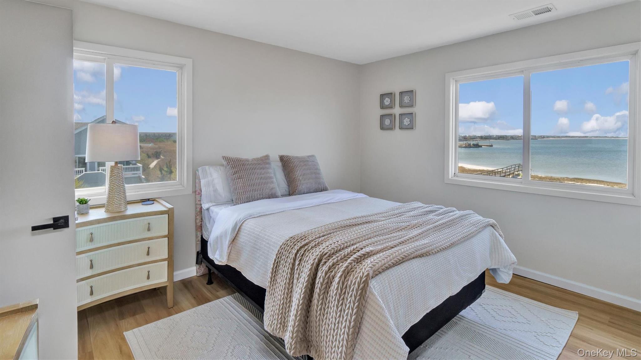 552 Dune Road Westhampton, NY 11978 - Photo 31 of 32 a bedroom with a bed and large window