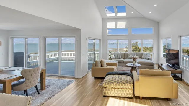 a living room with furniture fireplace and wooden floor