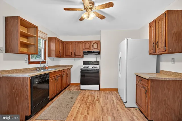 a kitchen with stainless steel appliances granite countertop a stove cabinets and entryway