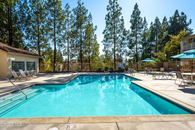 a view of swimming pool with sitting area and furniture