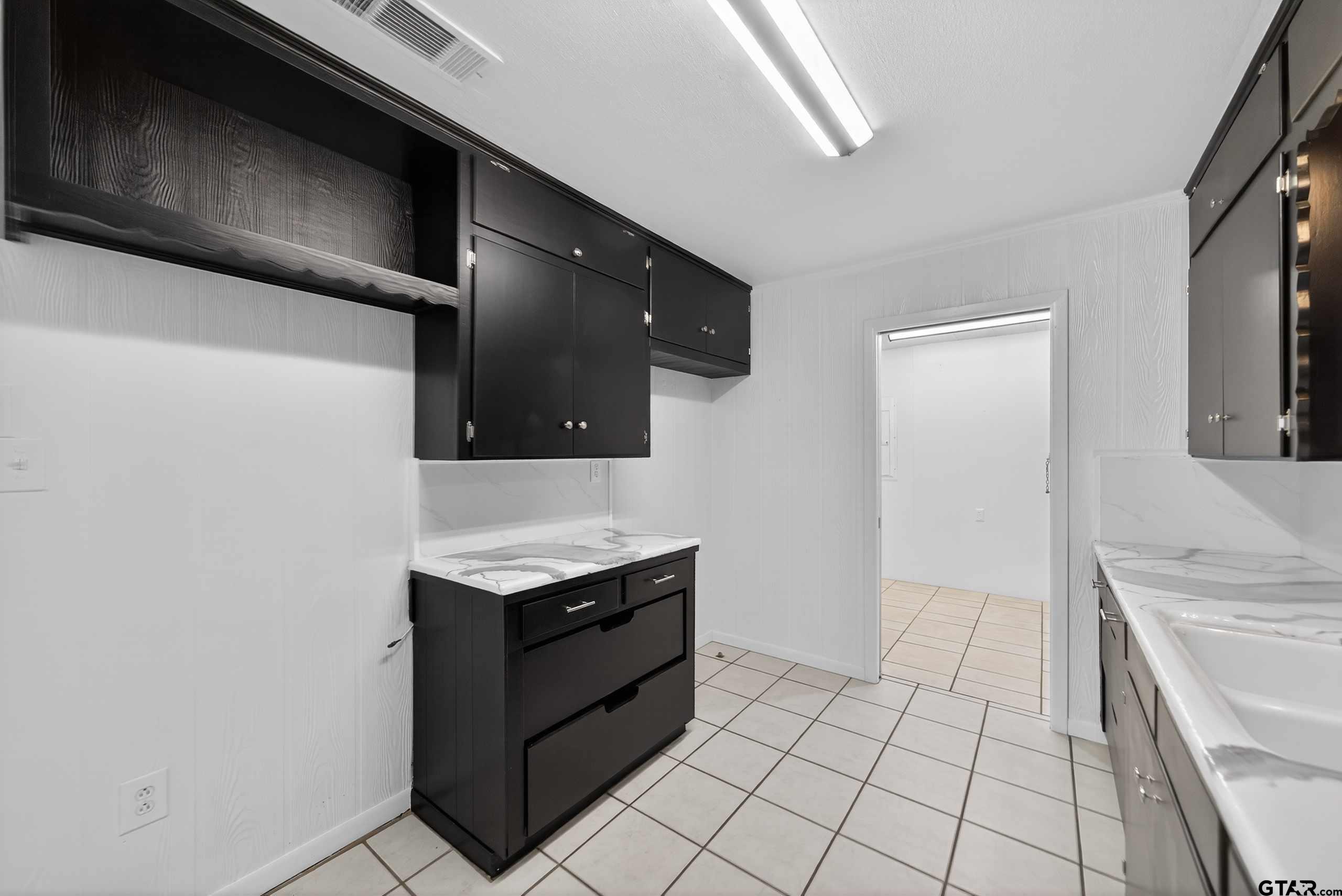 11457 State Highway 64 Tyler, TX 75707 - Photo 18 of 43 a kitchen with stainless steel appliances granite countertop a sink and a stove