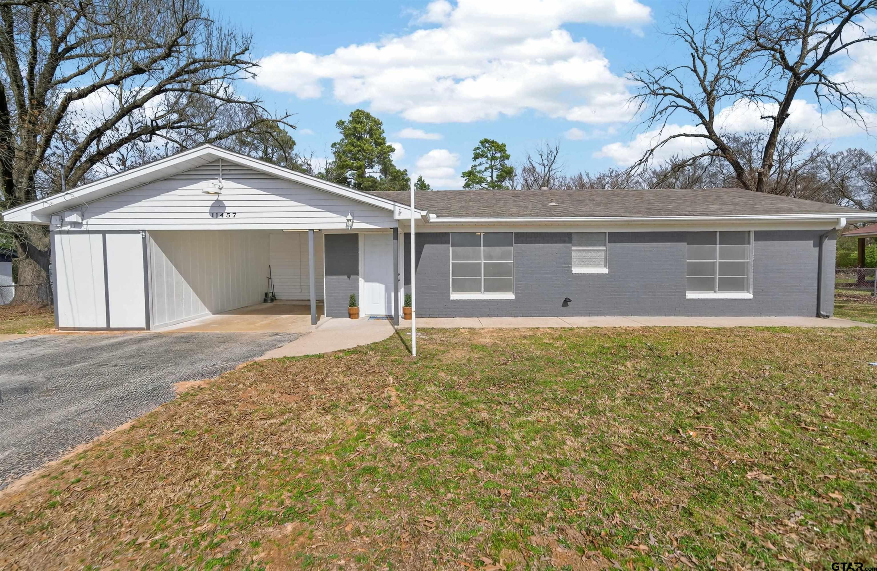 11457 State Highway 64 Tyler, TX 75707 - Photo 3 of 43 a front view of a house with a yard and garage