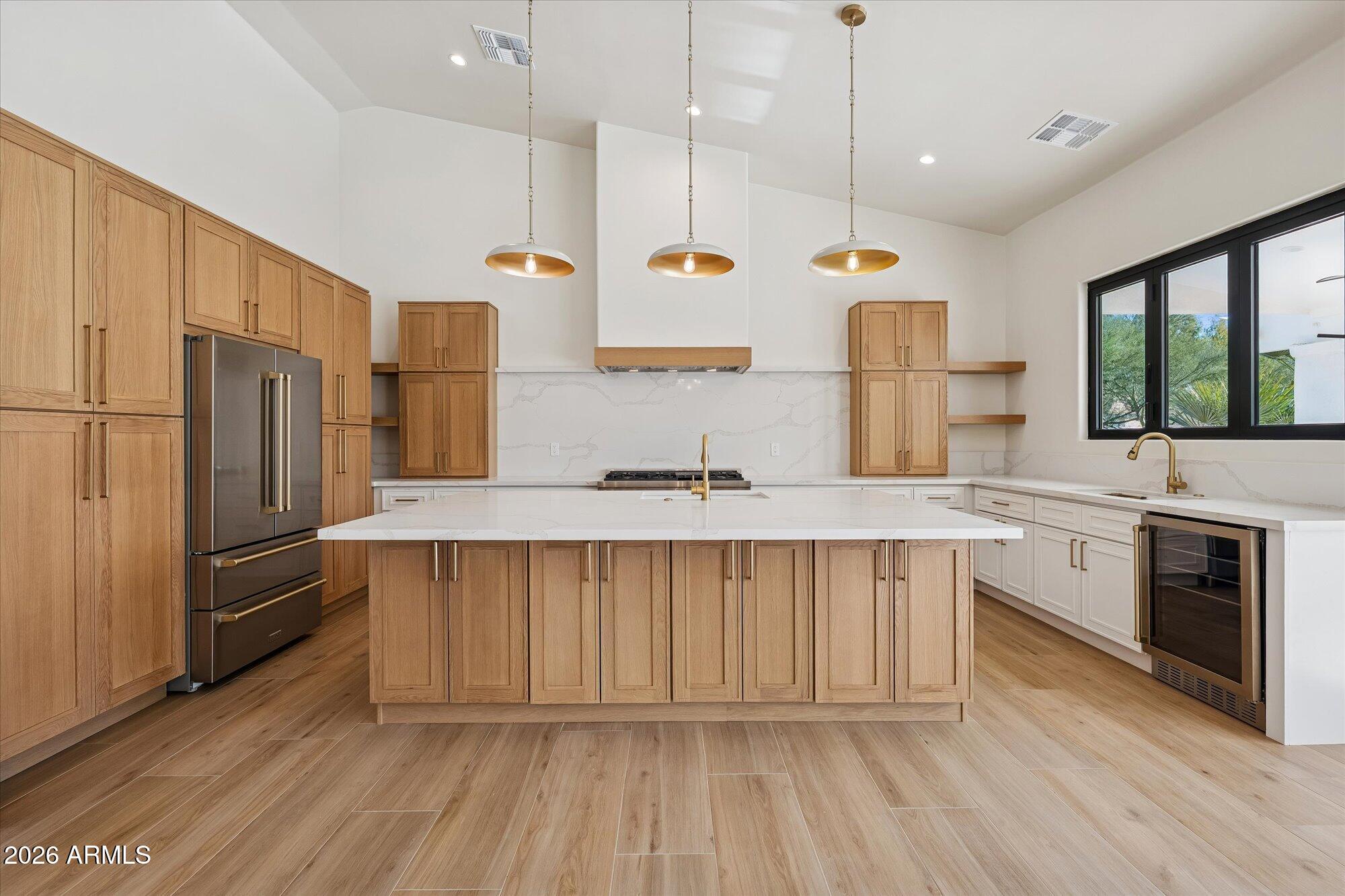 a kitchen with kitchen island white cabinets and stainless steel appliances