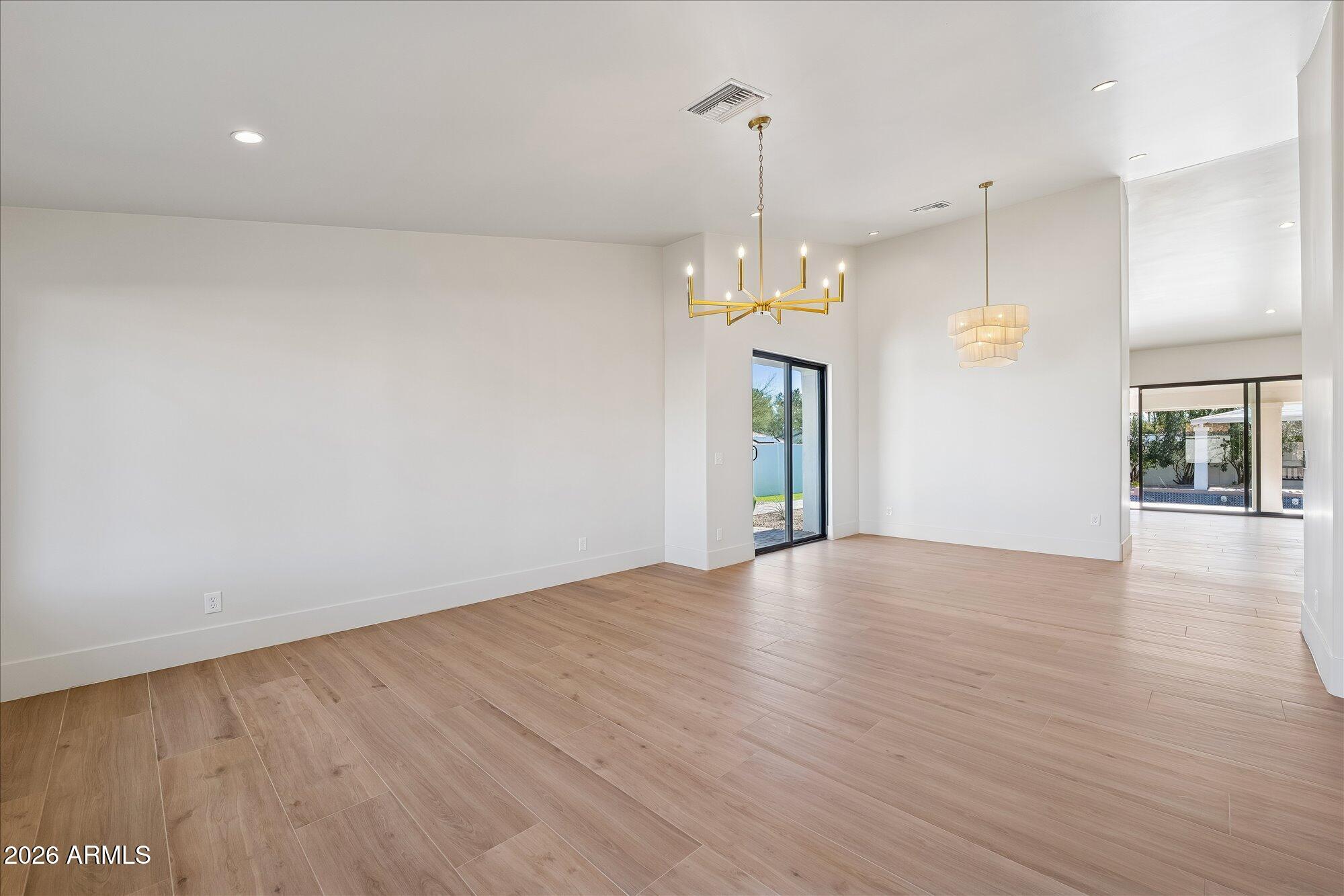 5861 East St John Road Scottsdale, AZ 85254 - Photo 14 of 60 an empty room with wooden floor and windows