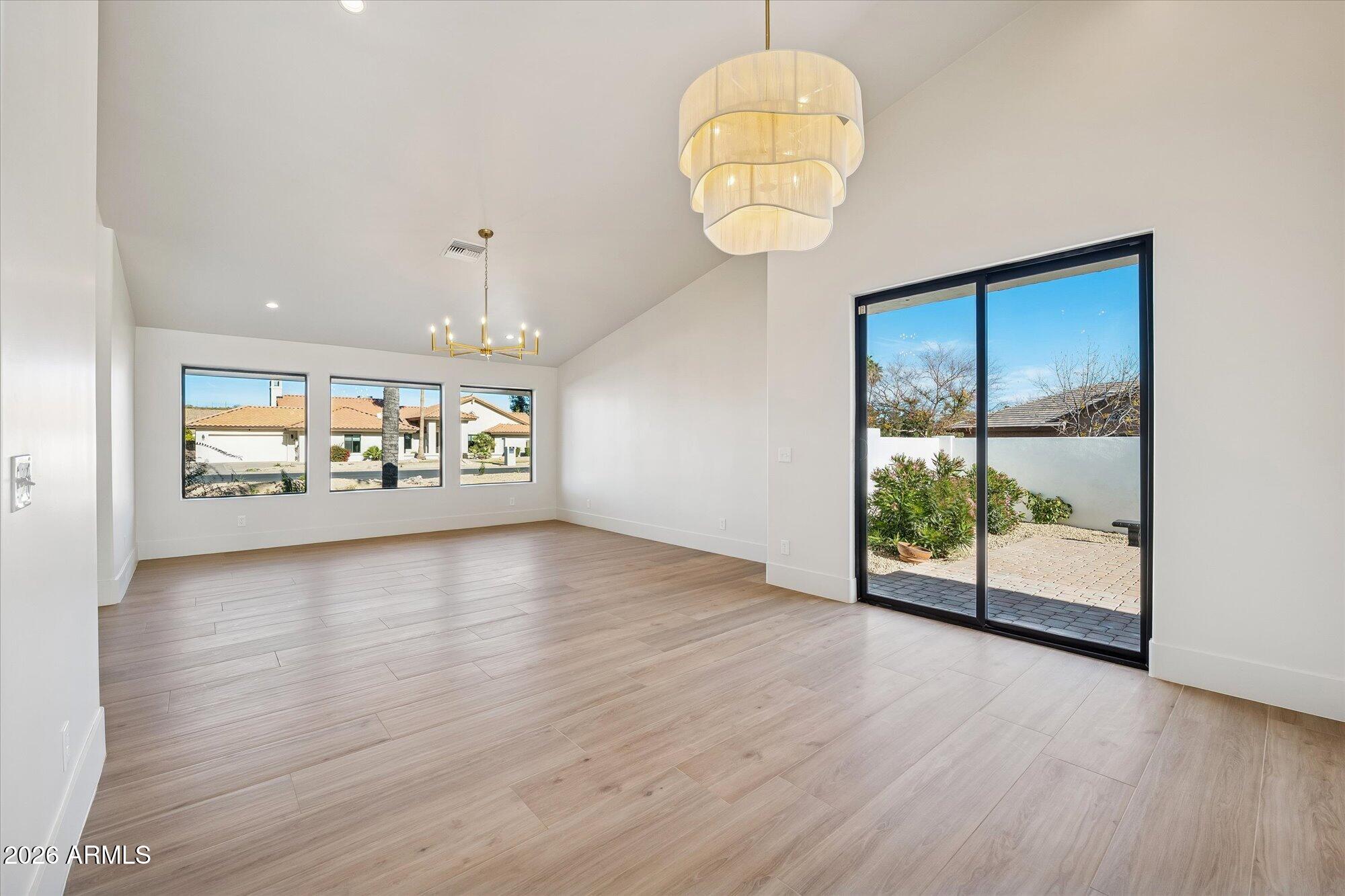5861 East St John Road Scottsdale, AZ 85254 - Photo 19 of 60 a view of an empty room with a window and wooden floor
