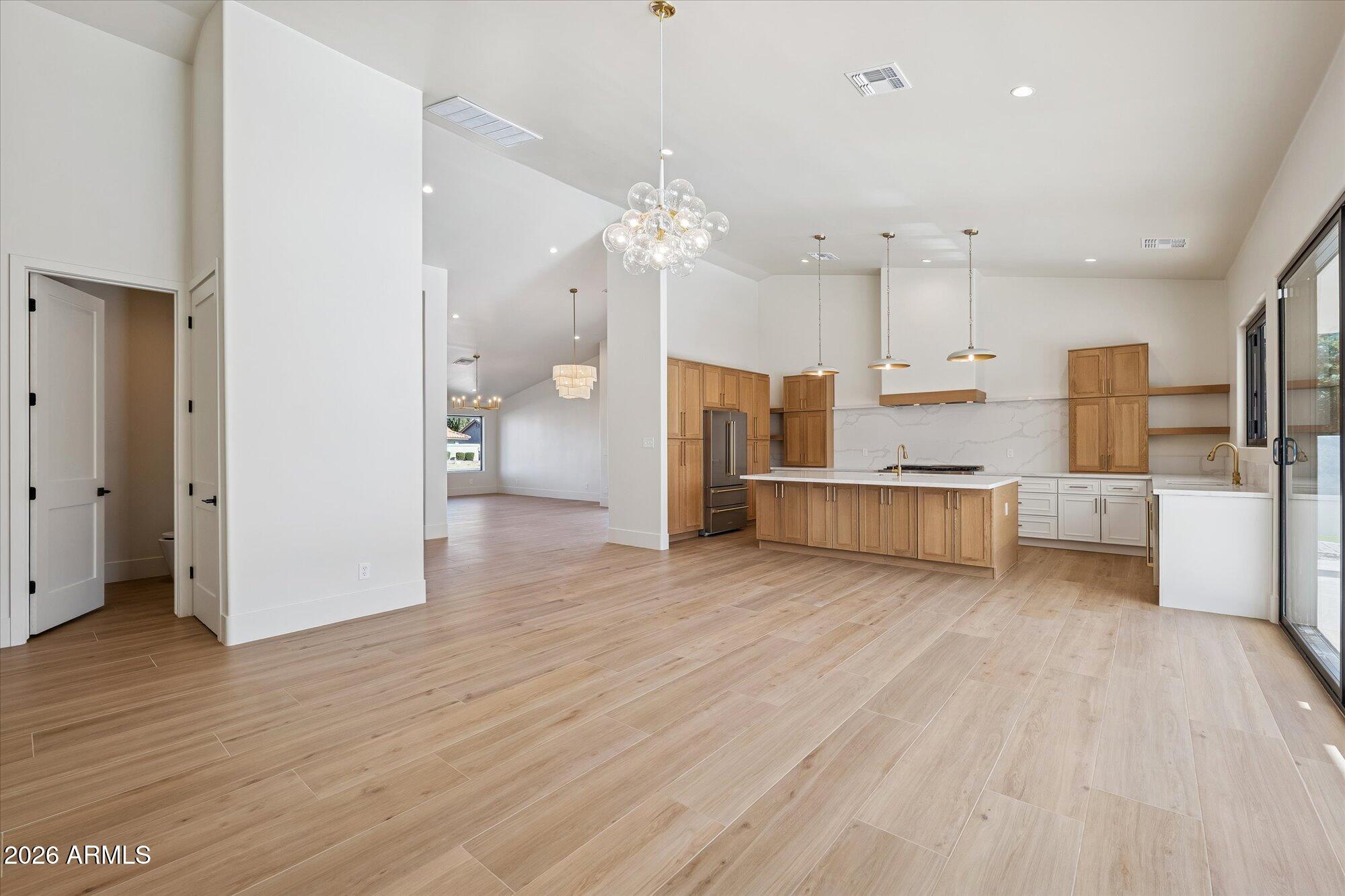 5861 East St John Road Scottsdale, AZ 85254 - Photo 20 of 60 a view of a kitchen with wooden floor and a refrigerator