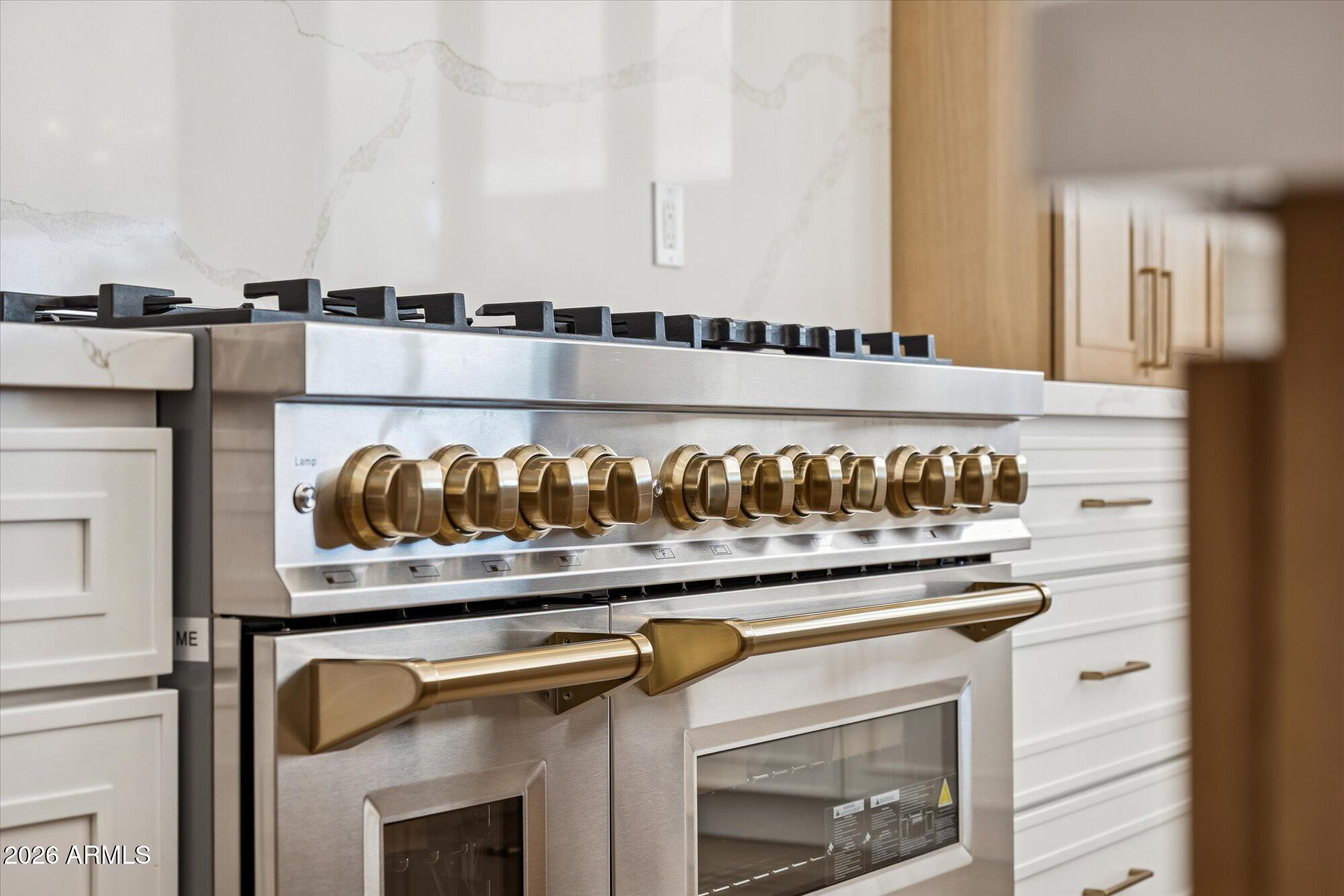 5861 East St John Road Scottsdale, AZ 85254 - Photo 22 of 60 a view of a kitchen with an oven a fireplace and cabinets