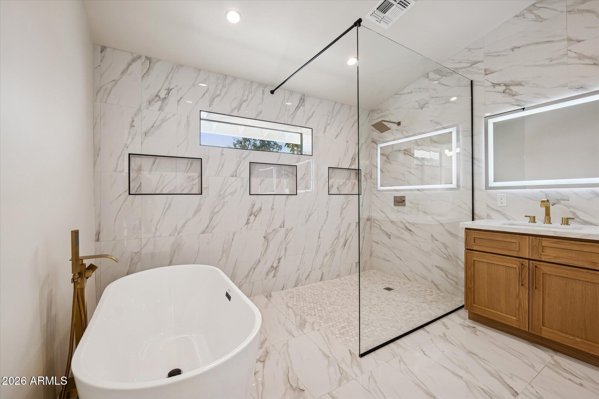 5861 East St John Road Scottsdale, AZ 85254 - Photo 27 of 60 a bathroom with a bathtub shower sink vanity and mirror