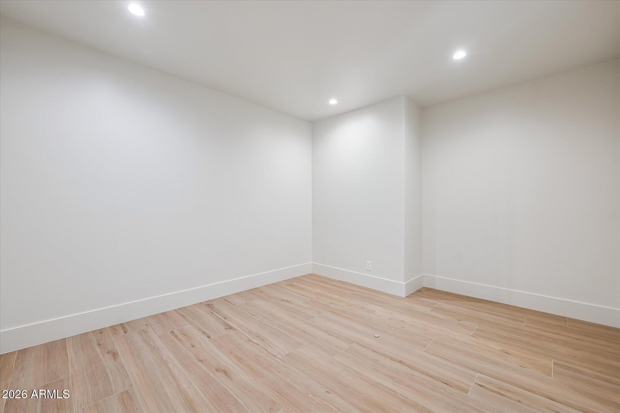 5861 East St John Road Scottsdale, AZ 85254 - Photo 29 of 60 an empty room with wooden floor and windows