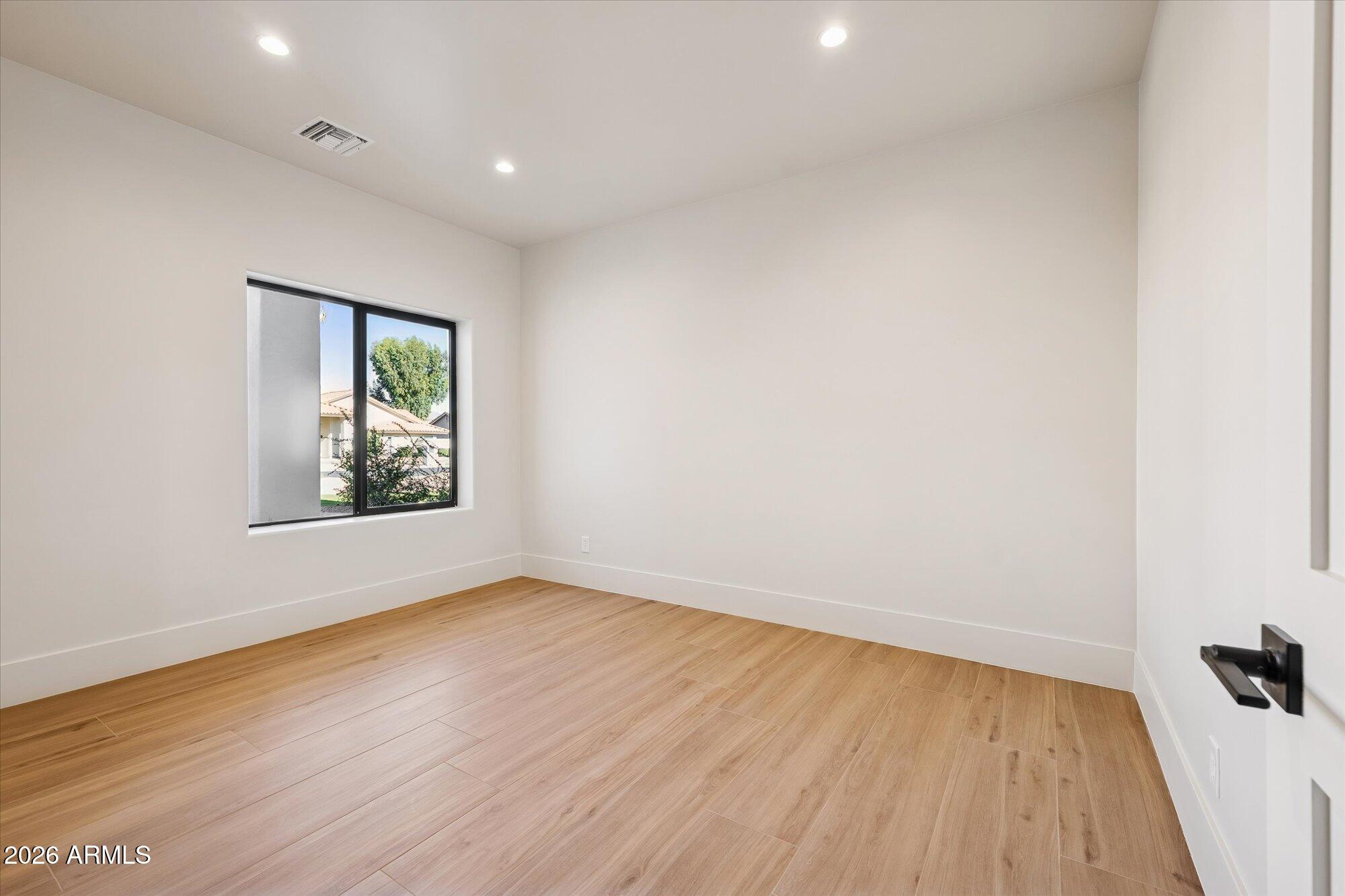 5861 East St John Road Scottsdale, AZ 85254 - Photo 33 of 60 a view of an empty room with wooden floor and a window