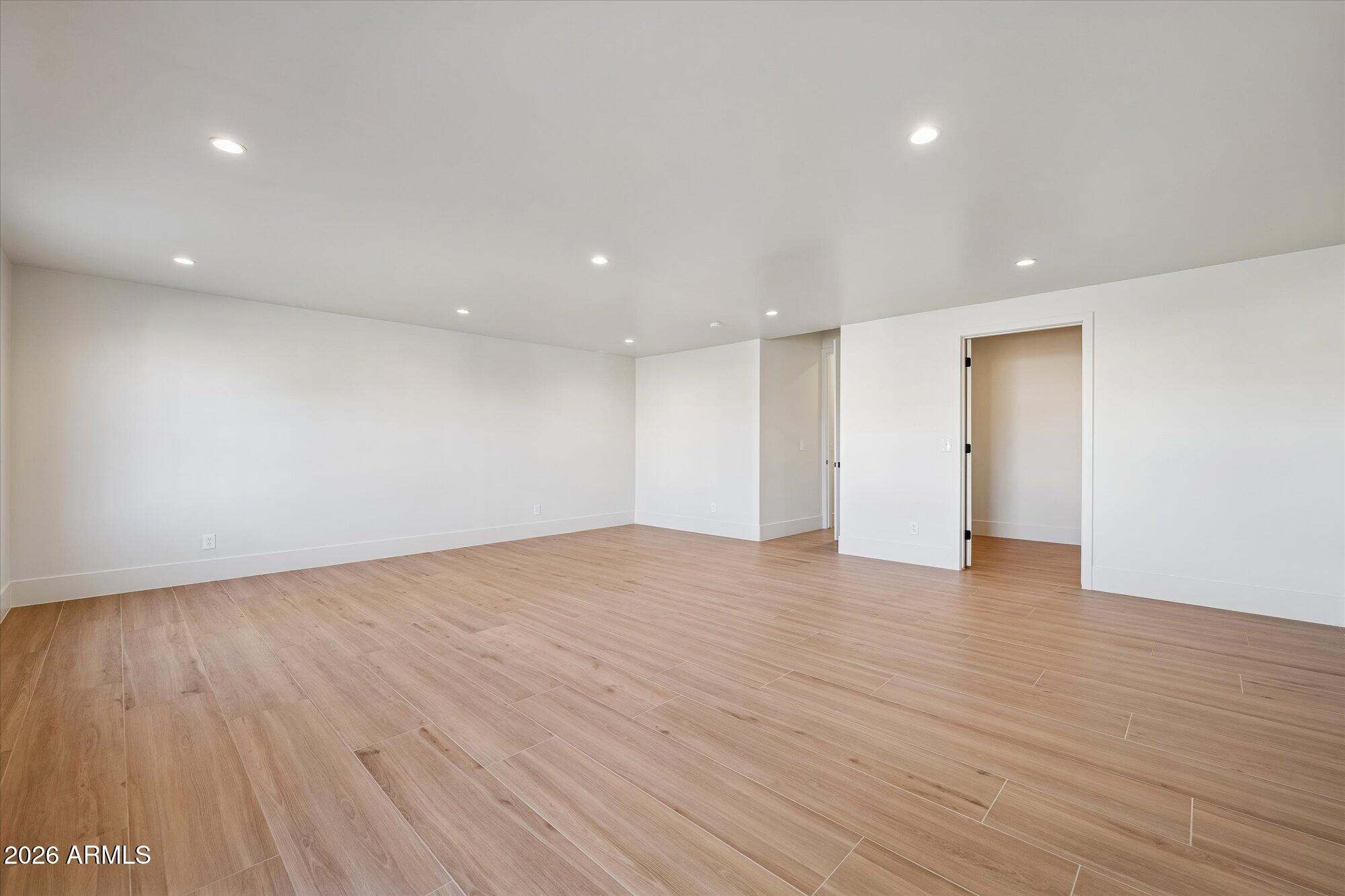 5861 East St John Road Scottsdale, AZ 85254 - Photo 36 of 60 a view of an empty room with wooden floor and closet