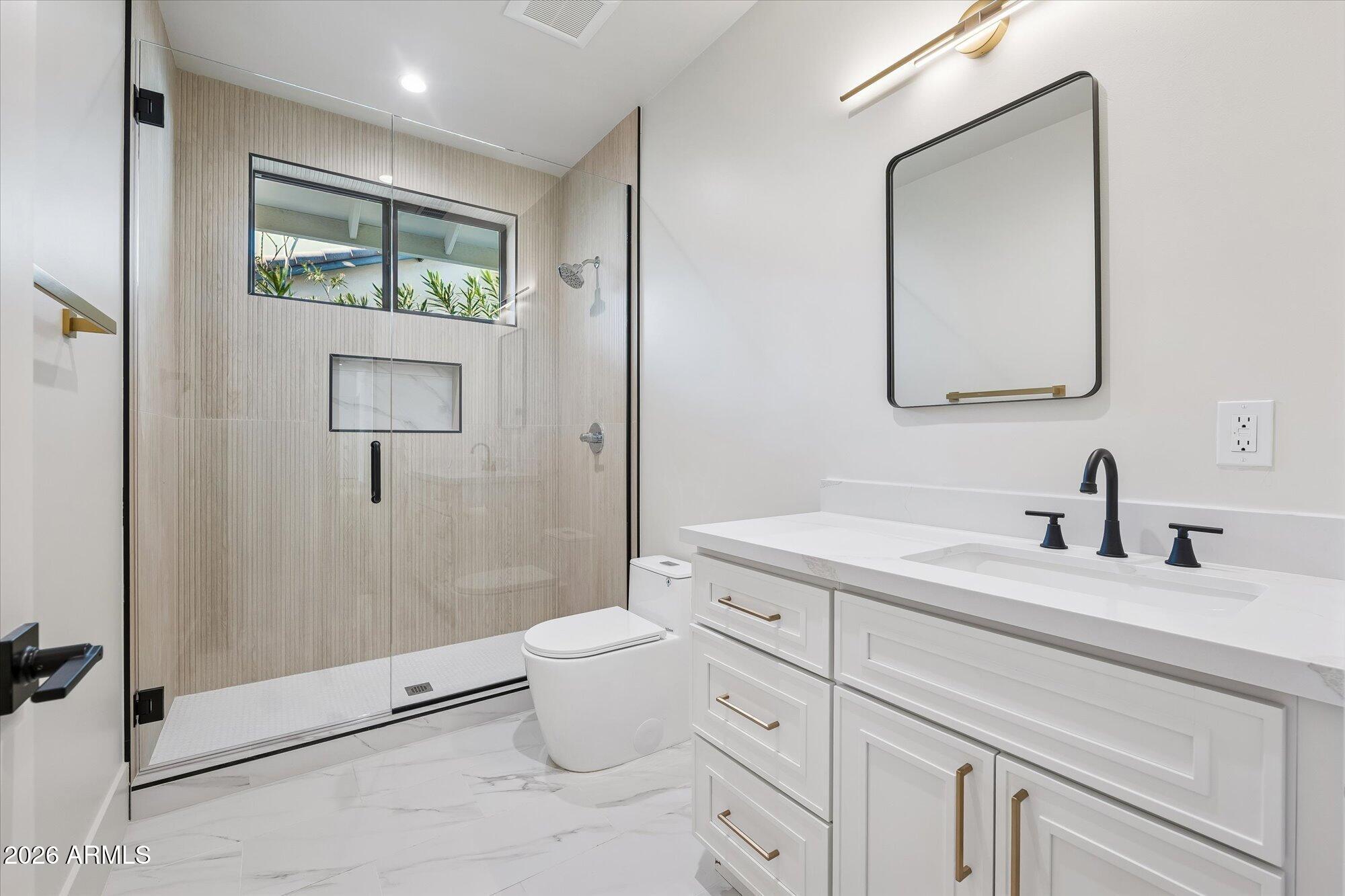 5861 East St John Road Scottsdale, AZ 85254 - Photo 39 of 60 a bathroom with a granite countertop sink mirror vanity and toilet