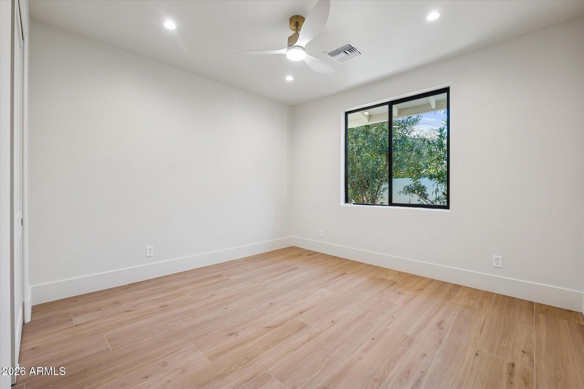 5861 East St John Road Scottsdale, AZ 85254 - Photo 40 of 60 an empty room with wooden floor and windows