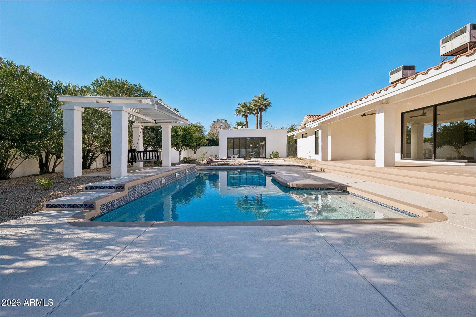 5861 East St John Road Scottsdale, AZ 85254 - Photo 50 of 60 a house with a bench in front of it