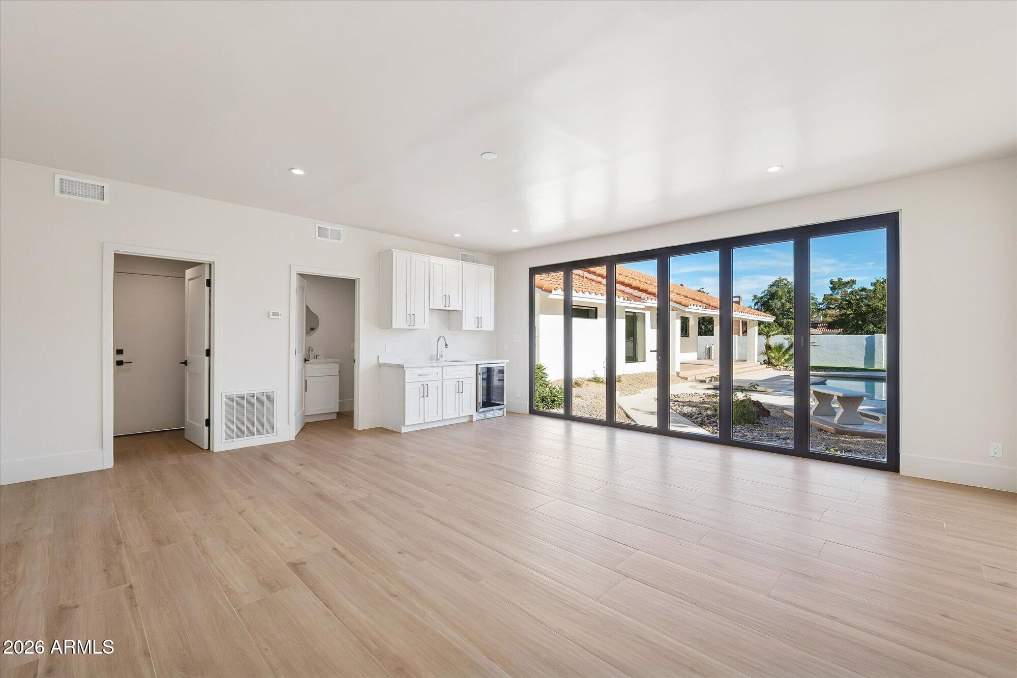 5861 East St John Road Scottsdale, AZ 85254 - Photo 5 of 60 a view of an empty room with wooden floor and a window
