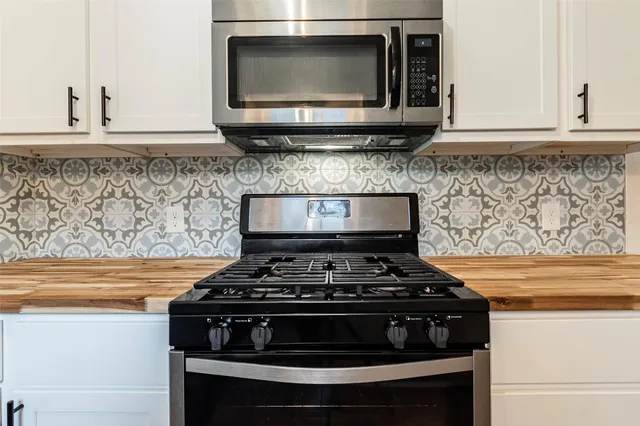a stove top oven sitting inside of a kitchen